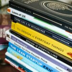 stack of books on brown wooden table